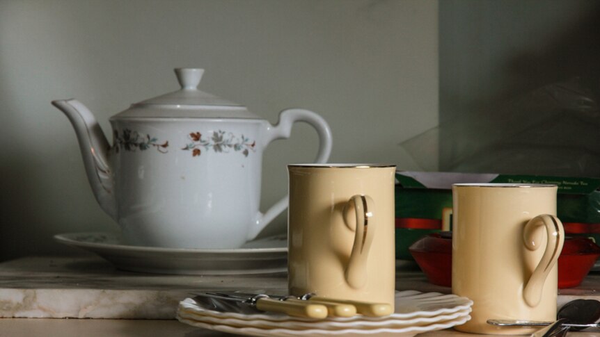 A teapot and cup and saucers in a farm house