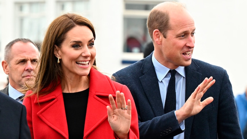 A close up of Kate and Will waving with big smiles.