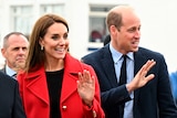 A close up of Kate and Will waving with big smiles.