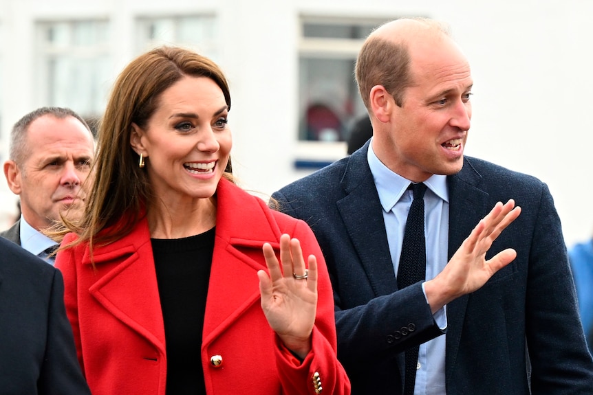 A close up of Kate and Will waving with big smiles.
