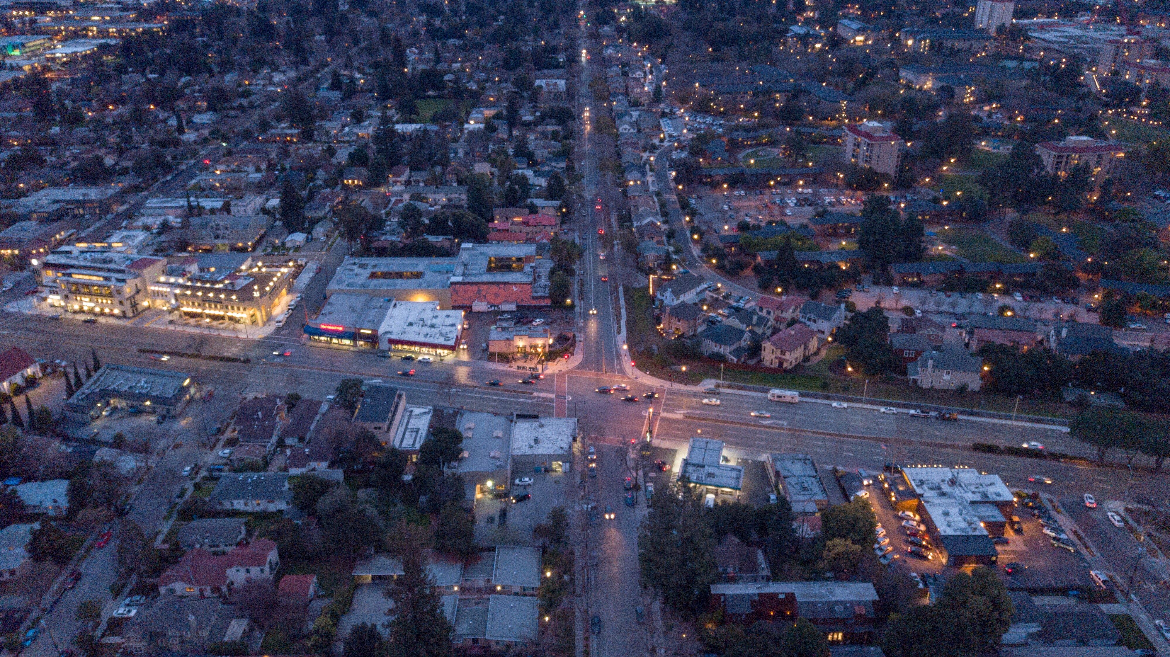 Sprawling suburbia with a bay and mountains in the background.