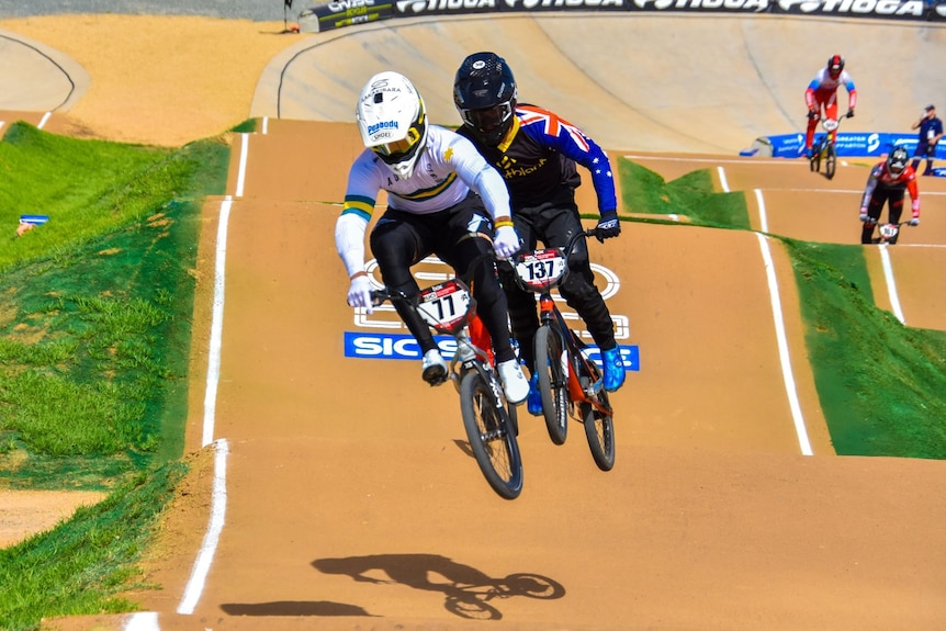 BMX riders going around a track