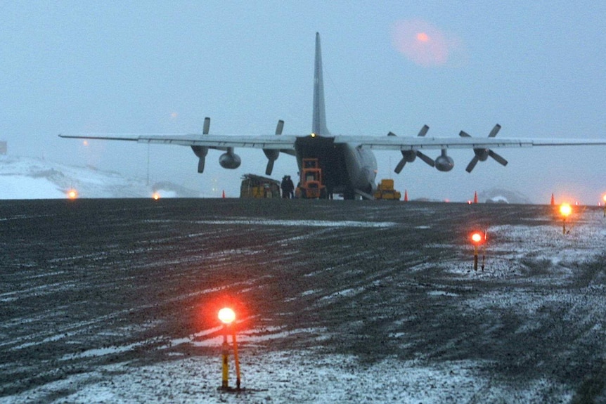 A C-130 transport aircraft unloads cargo