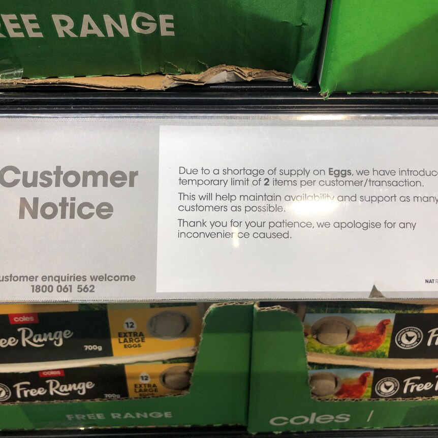 A customer notice sign says customers can only buy two cartons of eggs due to a supply shortage.