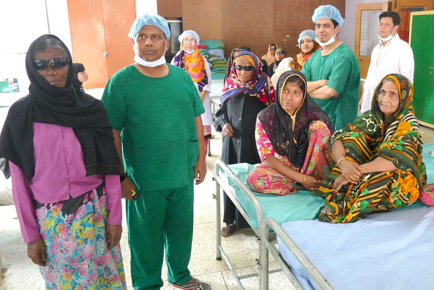 A group of women in hospital with male surgeons