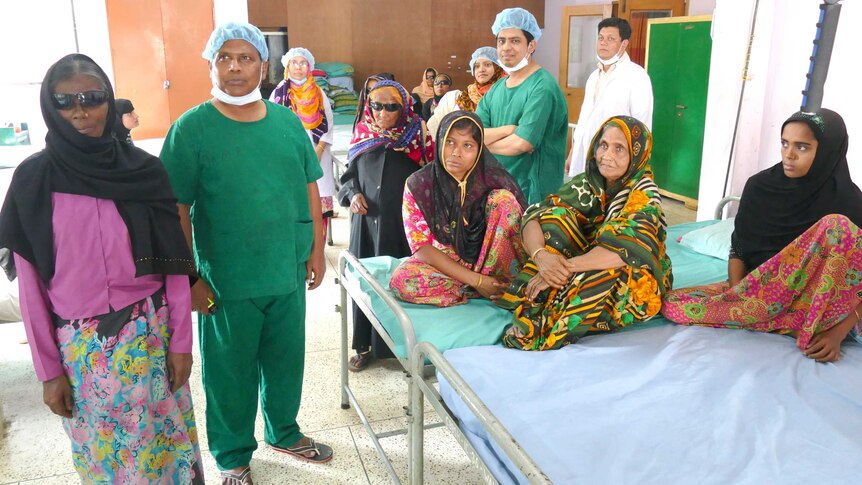 A group of women in hospital with male surgeons