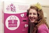 Nikki Bensch standing in front of a Share the Dignity sanitary vending machine.