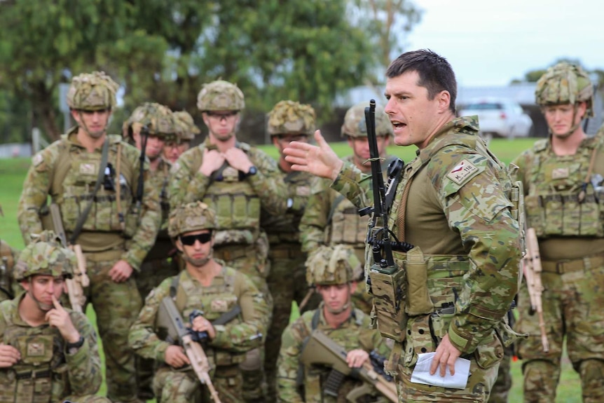 Major James Coltheart issues orders to his soldiers ahead of a training scenario.