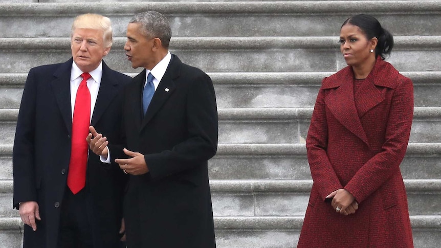 Michelle Obama looks stern while standing with Melania Trump, Donald Trump and Barack Obama