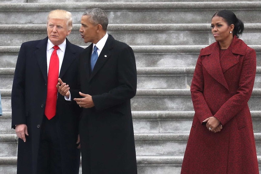 Michelle Obama looks stern while standing with Melania Trump, Donald Trump and Barack Obama