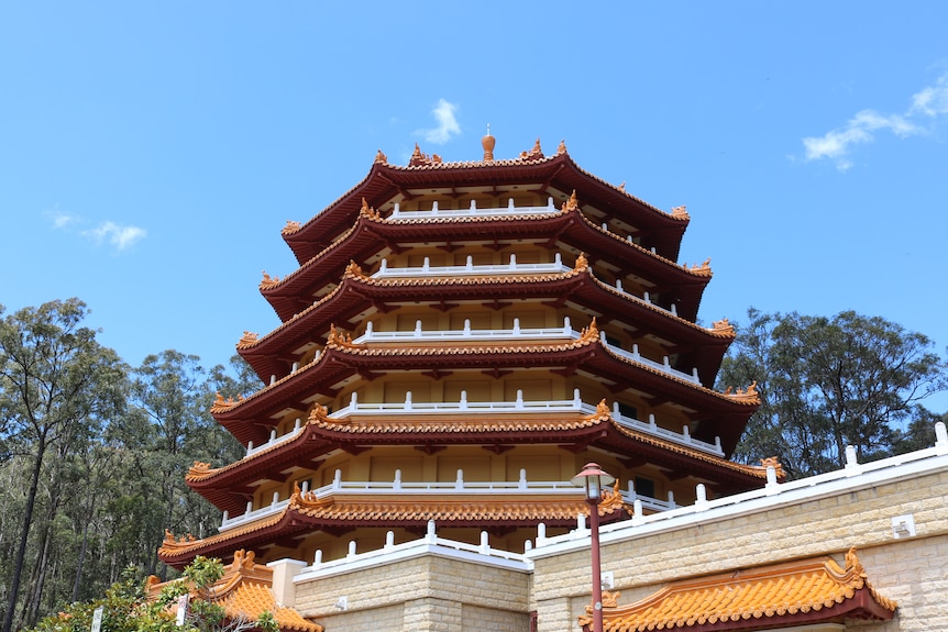 Beneath the pagoda against the clear blue Queensland sky.