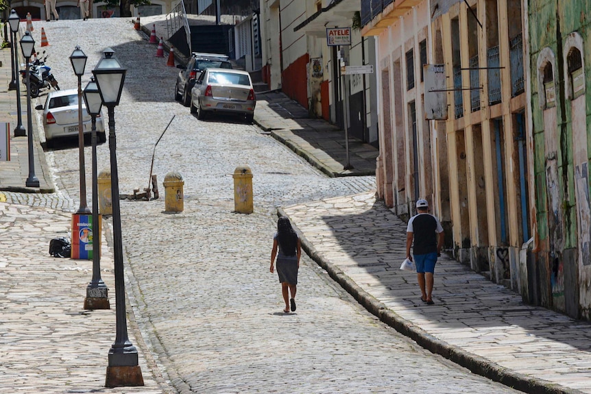 People walk in an empty street