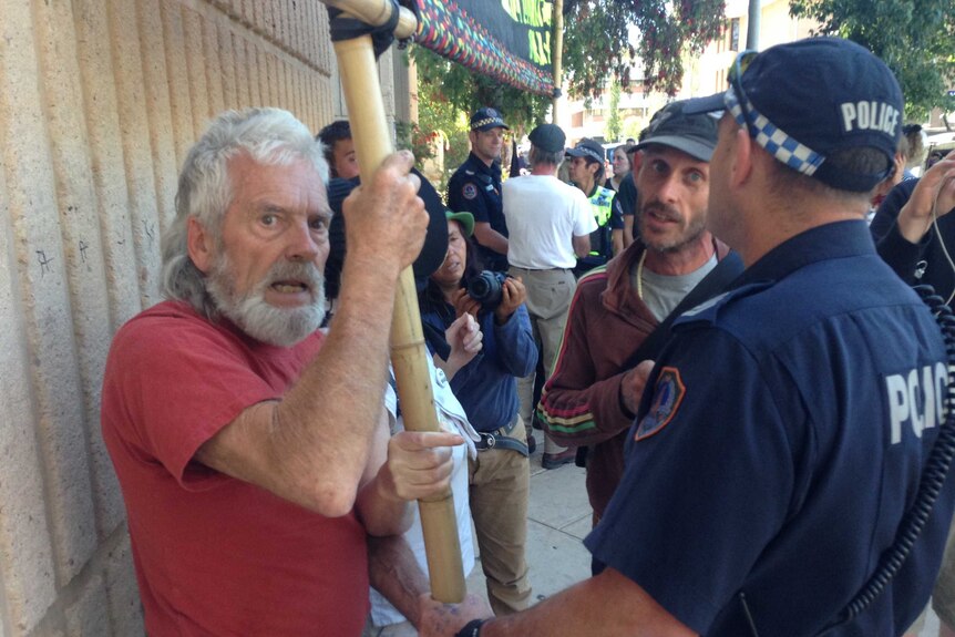 Pine Gap protestors clash with police outside court in Alice Springs.