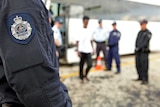 Australian Federal Police escort asylum seekers from Christmas Island to Nauru.