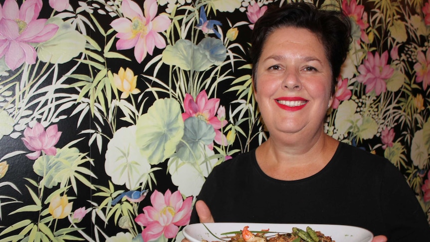 Bundaberg chef and cafe-owner Amanda Hinds holds her winning dish - bugtail, prawn, and finger lime omelette.