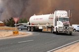 A CFS tanker takes water to the bushfire scene