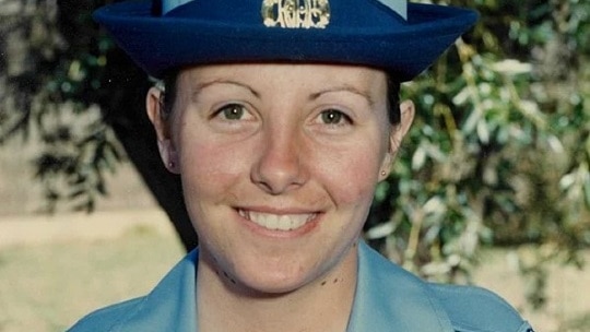 A film photograph of a young woman wearing a RAAF uniform and smiling.