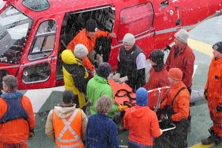 Patient being transferred to helicopter.