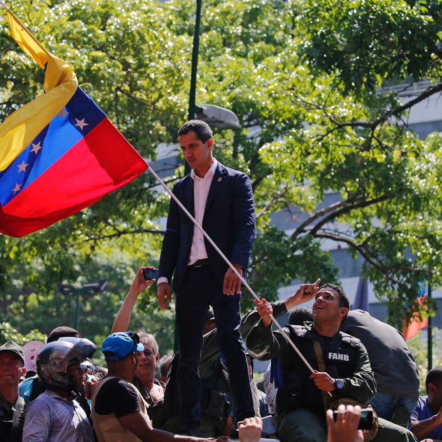 Juan Guaido calls for supporters and military outside of La Carlota military air base in Caracas.