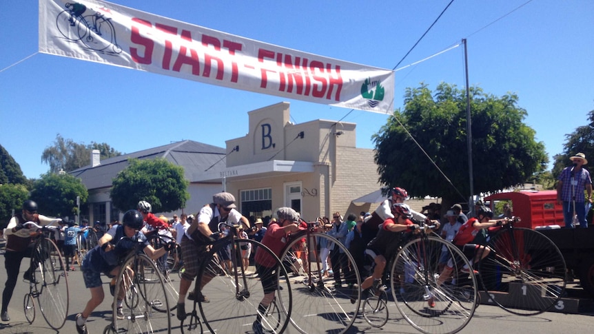 Penny farthing riders take off