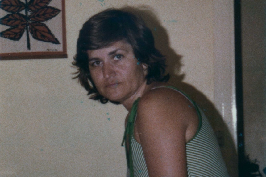 Maria James stands near a table looking at the camera