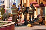 Firefighters outside a building in a country town.