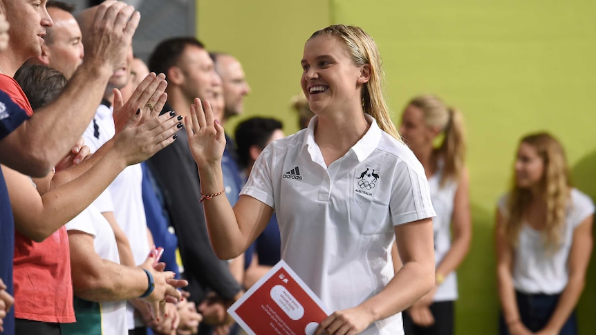 Georgia Bohl is congratulated by former Australian Olympians after receiving a Rio Olympic Games 'Boarding Pass'.