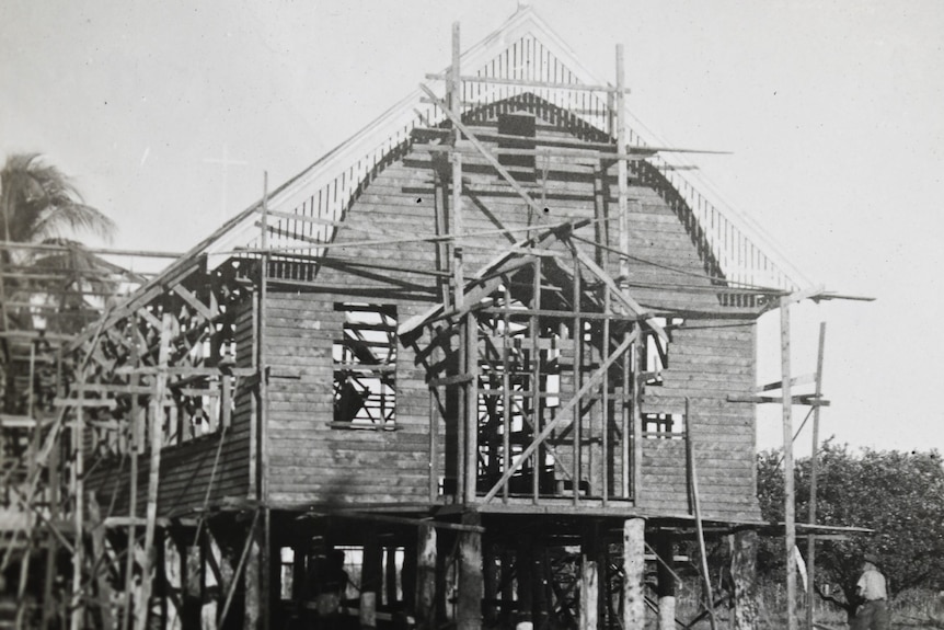 A black and white photograph of a timber church under construction on a remote island off northern Australia.