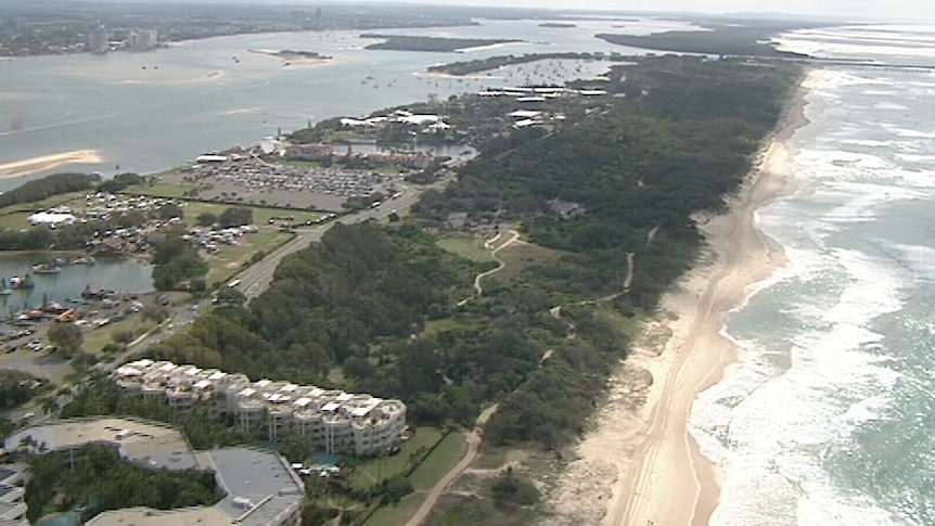 Aerial shot of Gold Coast spit, an inlet largely covered in trees.