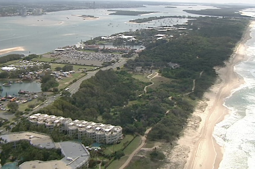 Aerial shot of Gold Coast spit, an inlet largely covered in trees.