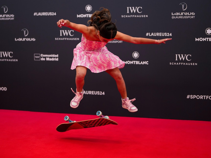 Arisa Trew photographed in mid-air above her skateboard while doing a trick on the red carpet at the Laureus sport awards.