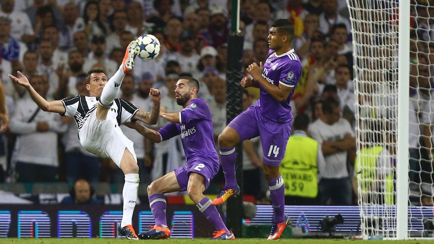 Mario Mandzukic gets boot to ball ahead of scoring a sensational goal for Juventus.