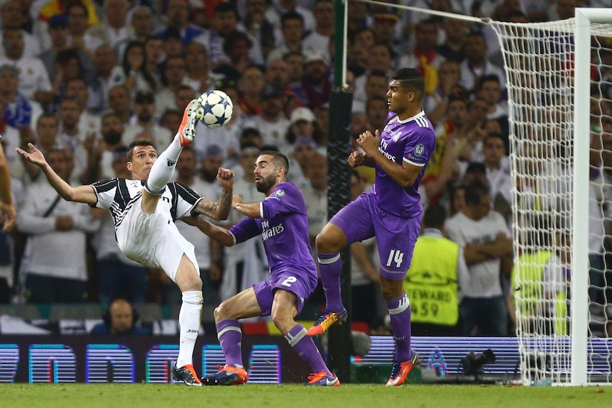 Mario Mandzukic gets boot to ball ahead of scoring a sensational goal for Juventus.