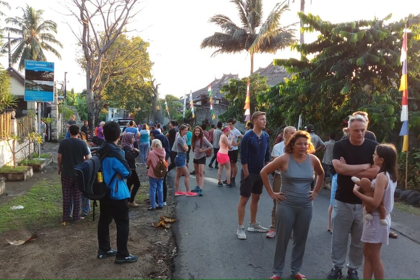 Tourists stand outside after Lombok earthquake