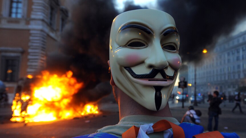 A protester wears a Guy Fawkes masks during a demonstration in Rome on October 15, 2011.