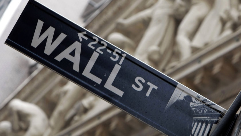 A Wall Street sign in front of the New York Stock Exchange.