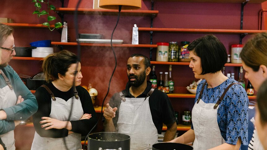 Niro Vithyasekar teaching a cooking class in the Free to Feed kitchen.