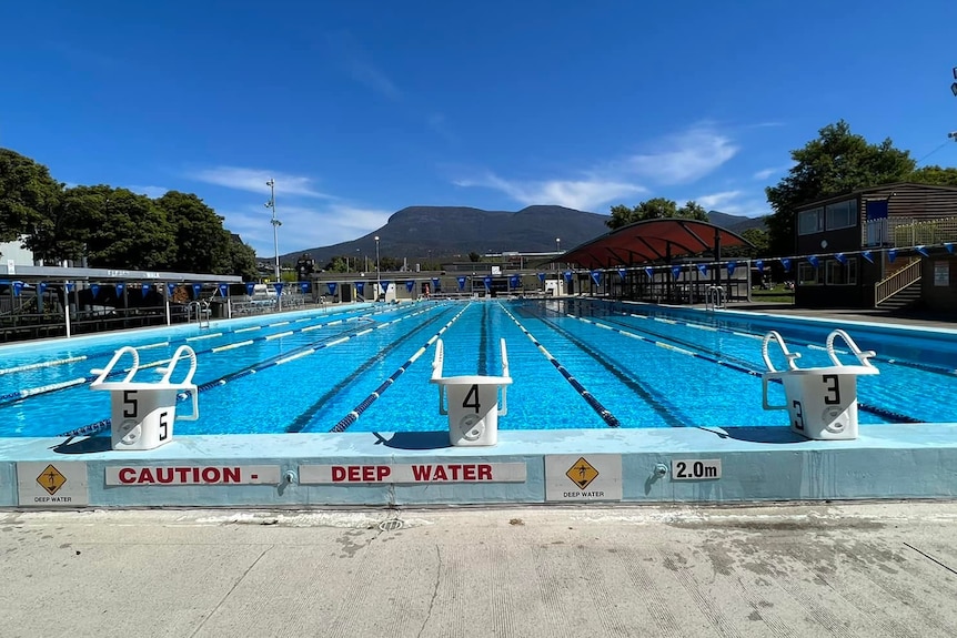 Glenorchy War Memorial Pool with kunanyi/Mount Wellington in the background and blue sky