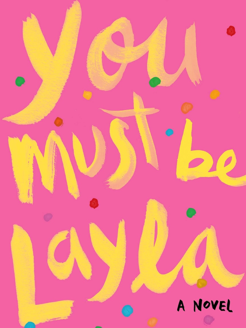Pink books cover with words in yellow: You Must Be Layla - A Novel.