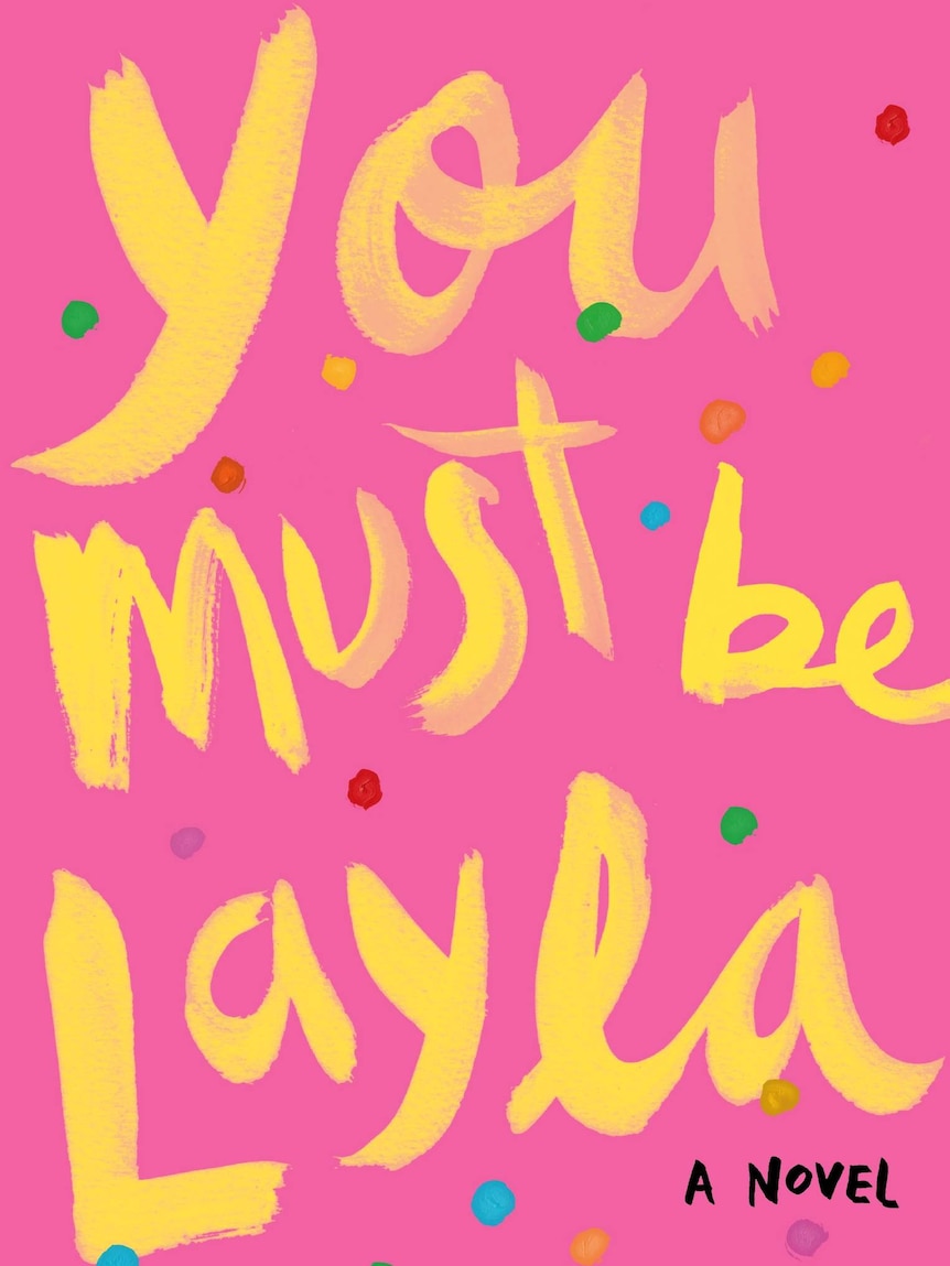 The bright pink book cover of You Must Be Layla