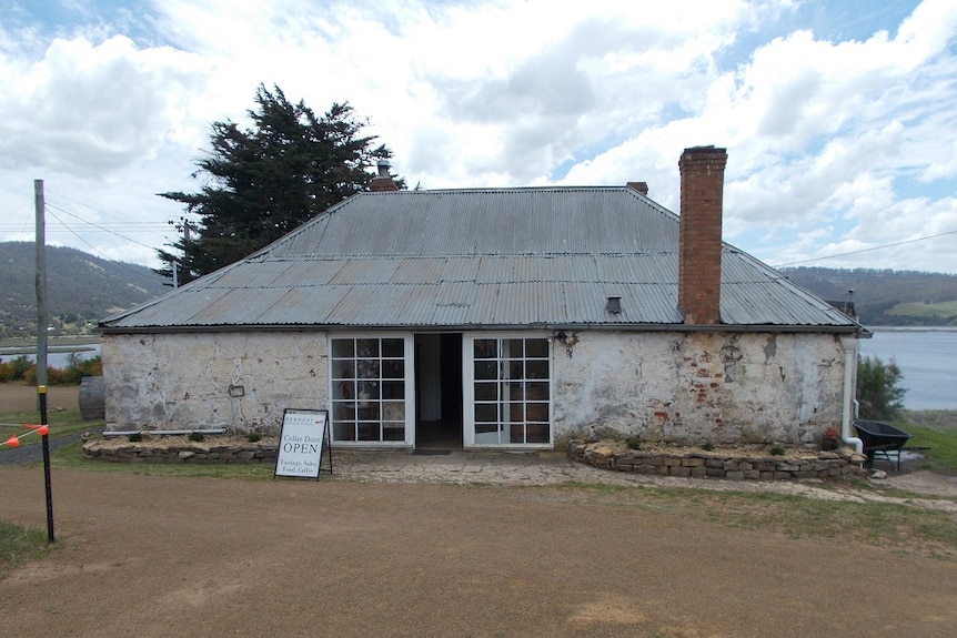 A very old single story building with iron roof used as a cellar door at Derwent Estate Winery at Granton in southern Tasmania