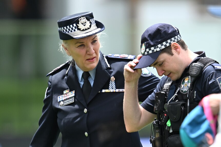 Katarina Carroll puts her arm on the shoulder of a young constable.