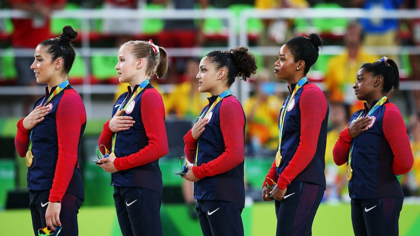 Team USA on the podium as the national anthem plays after their gold medal win