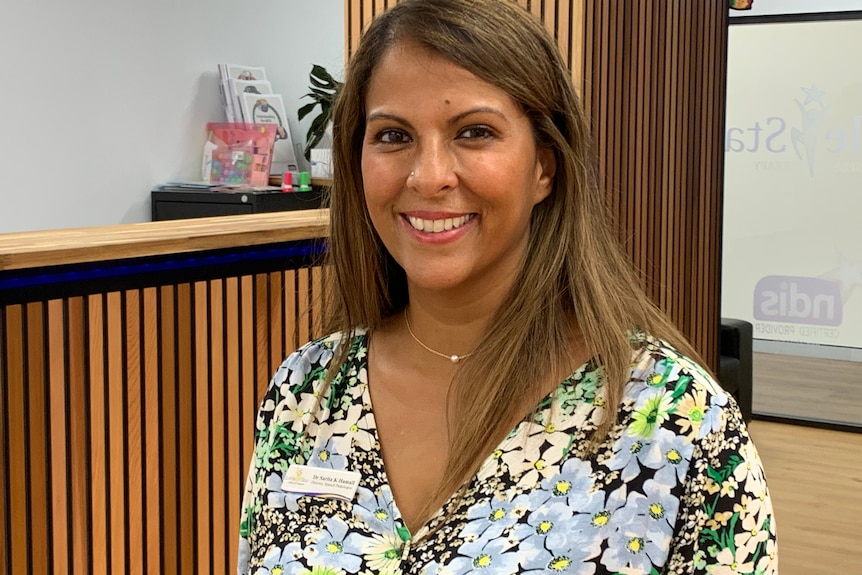 A woman standing in front of reception counter.