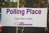 An Australian Electoral Commission banner tied to a fence. It says "polling place" with opening hours 8am-6pm