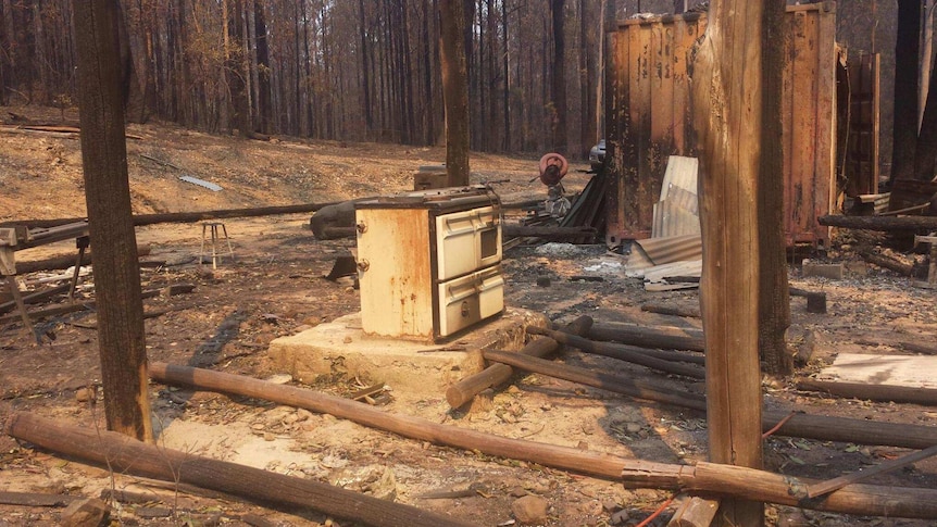 A burnt out home where only the stove is left standing.