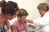 A boy receives a Q fever vaccination.