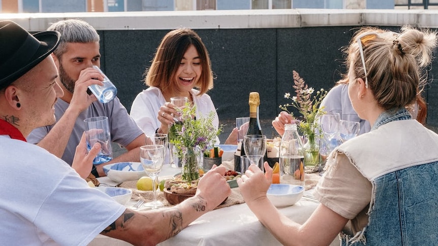 A group of people sharing a meal outside.