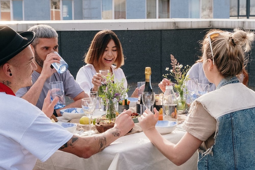 A group of people sharing a meal outside.