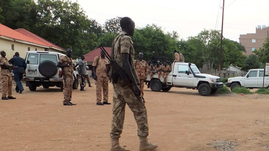 South Sudanese policemen and soldiers standing in a street.